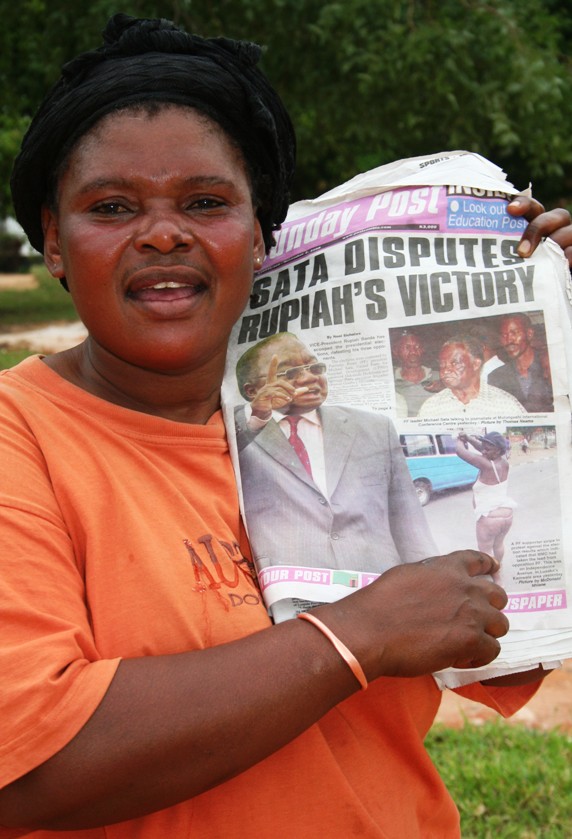 Moria displaying a copy of a newspaper carrying a picture of a naked Patriotic Front member who was protesting against the victory of the ruling MMD candidate Rupiah Banda in the October 30th, Presidential Elections